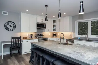 a kitchen with white cabinets and a large counter top at 107 Birchview Trail in Blue Mountains