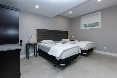a bedroom with two beds and a flat screen tv at 107 Birchview Trail in Blue Mountains