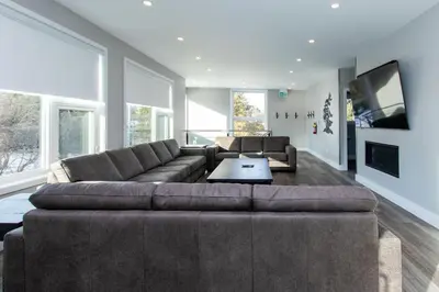 a living room with a large couch and a tv at 107 Birchview Trail in Blue Mountains