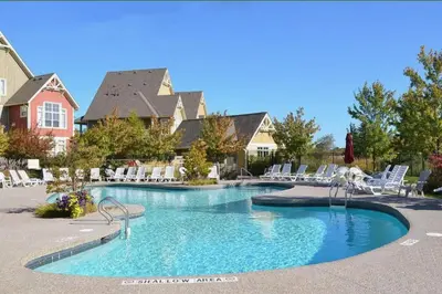 a swimming pool in a resort with white chairs at Great Location, Pool, Blue Mountain 2 BDRM Dream in Blue Mountains
