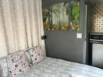 a bedroom with a bed with two pillows on it at Love-nest With Private Hot Tub in Toronto