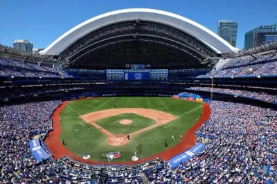 a baseball game in a stadium with a large crowd at Elegant Downtown Condo Near CN Tower -FREE Parking in Toronto