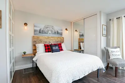 a bedroom with a bed with red and black pillows at Blue Mountain Creekside Studio at North Creek Resort in Blue Mountains