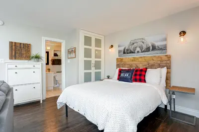 a bedroom with a bed with a picture on the wall at Blue Mountain Creekside Studio at North Creek Resort in Blue Mountains
