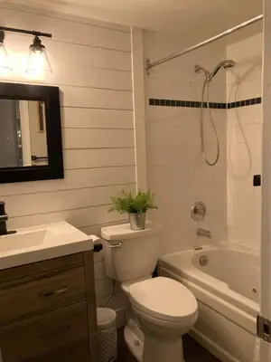 a bathroom with a toilet and a sink and a tub at Blue Mountain Creekside Studio at North Creek Resort in Blue Mountains