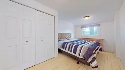 a bedroom with a bed and a large closet at Main Beach River Retreat - Wasaga Beach 1 - Main Strip - 95 Mosley St in Wasaga Beach