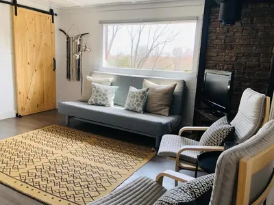 a living room with a couch and a window at The hidden nest in Marmora