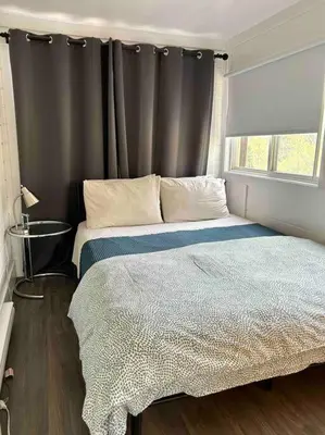 a bedroom with a large bed with a window at The hidden nest in Marmora