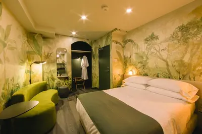 a bedroom with a large bed and plants on the walls at Ode in Toronto