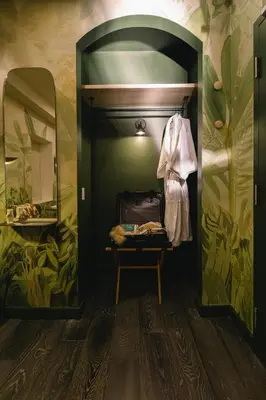 a dressing room with a suitcase and a mirror at Ode in Toronto
