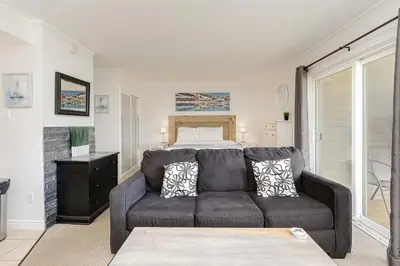 a living room with a couch and a bed at Blue Mountain Studio Oasis in Blue Mountains