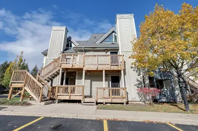 a house with a deck on a street at Blue Mountain Studio Oasis in Blue Mountains