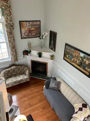 a living room with a couch and a fireplace at The Jypsy Inn Chambre Damour Bracebridge in Bracebridge