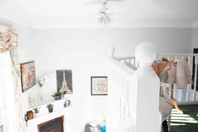 a living room with a staircase and a person walking up the stairs at The Jypsy Inn Chambre Damour Bracebridge in Bracebridge