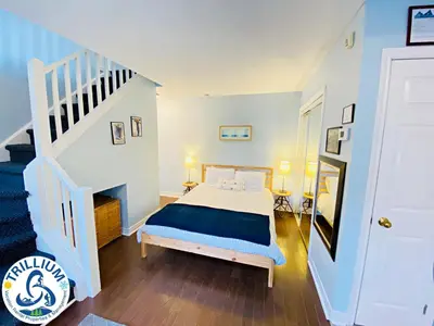 a bedroom with a bed and a staircase at Cozy Studio Loft with 2 Baths Next to Slopes in Blue Mountains