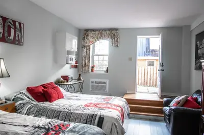 a bedroom with two beds and a window at The Jypsy Inn Notting Hill in Bracebridge