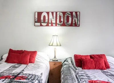 a bedroom with two beds and a sign that reads london at The Jypsy Inn Notting Hill in Bracebridge