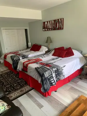 a bedroom with two beds and a sign that reads london at The Jypsy Inn Notting Hill in Bracebridge