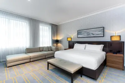 a hotel room with a bed and a couch at Sutton Place Hotel Toronto in Toronto