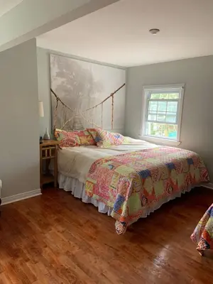 a bedroom with a bed and a window at The Jypsy Inn - Journey Apartment Muskoka in Bracebridge