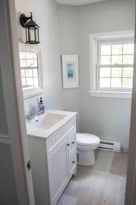 a bathroom with a white sink and a toilet at The Jypsy Inn - Journey Apartment Muskoka in Bracebridge