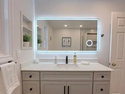 a bathroom with a sink and a large mirror at The Promenade Cottage License # 002-2023 in Niagara on the Lake