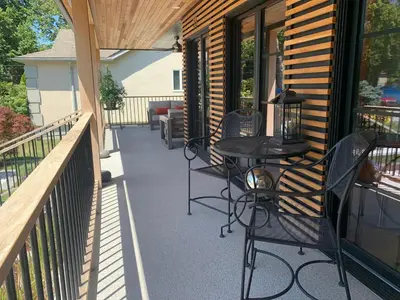 a patio with a table and chairs on a porch at 33 On Gage Garden Suite in Niagara on the Lake