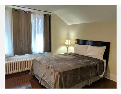 a bedroom with a large bed with a window at House in Niagara falls, Close to Clifton Hill, Casino and Horseshoe falls and with kitchen for 6 Guest in Niagara Falls