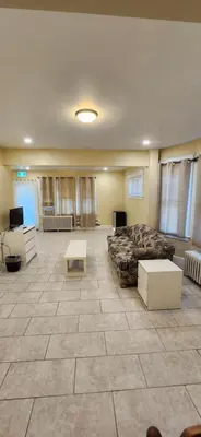 a large room with a bed and a table at House in Niagara falls, Close to Clifton Hill, Casino and Horseshoe falls and with kitchen for 6 Guest in Niagara Falls