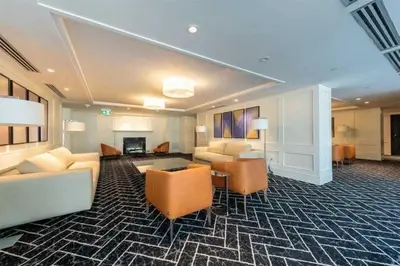 a hotel room with couches and chairs and a fireplace at Stylish Downtown Toronto Residential Hotel in Toronto