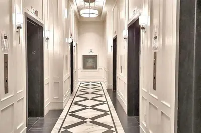 a hallway with black and white tiles on the floor at Stylish Downtown Toronto Residential Hotel in Toronto