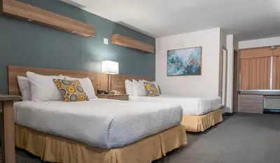 a hotel room with two beds in a room at Days Inn by Wyndham Niagara Falls Centre St By the Falls in Niagara Falls