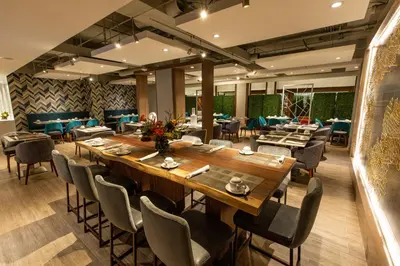 a dining room with a large wooden table and chairs at Holiday Inn Toronto Downtown Centre by IHG in Toronto