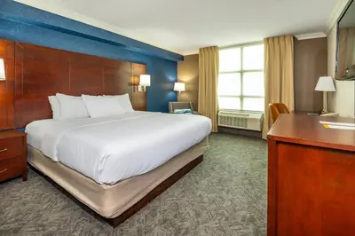 a hotel room with a large bed and a desk at Comfort Inn & Conference Centre Toronto Airport in Toronto
