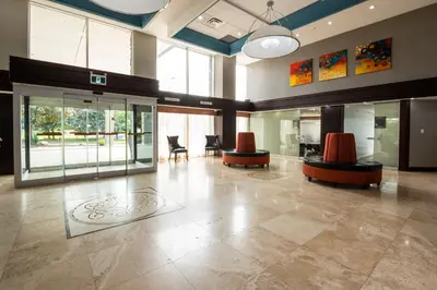 a large lobby with chairs and tables and windows at Comfort Inn & Conference Centre Toronto Airport in Toronto