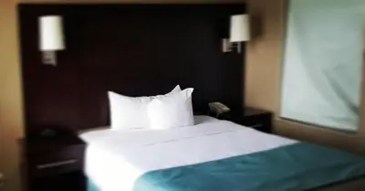 a bedroom with a bed with white sheets and pillows at Comfort Inn & Conference Centre Toronto Airport in Toronto