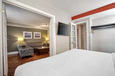 a bedroom with a bed and a living room at Town Inn Suites Hotel in Toronto