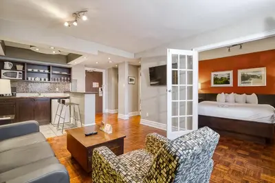 a hotel room with a bed and a kitchen at Town Inn Suites Hotel in Toronto