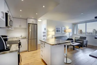 an open kitchen and living room in a apartment at Town Inn Suites Hotel in Toronto