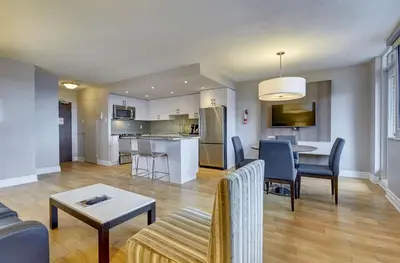 a living room with a couch and a table at Town Inn Suites Hotel in Toronto
