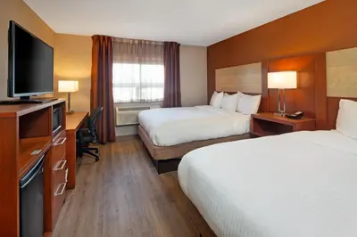 a hotel room with two beds and a flat screen tv at Canadas Best Value Inn-Richmond Hill in Richmond Hill