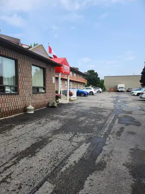 an empty parking lot in front of a building at Canadas Best Value Inn-Richmond Hill in Richmond Hill