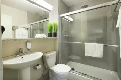 a bathroom with a toilet and a sink and a shower at Canadas Best Value Inn Toronto in Toronto