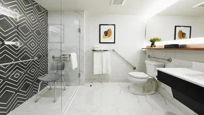 a bathroom with a shower and a toilet and a sink at Stay Inn Hotel Toronto in Toronto