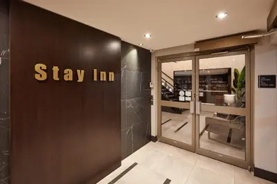 a store entrance with a sign that reads stay inn at Stay Inn Hotel Toronto in Toronto