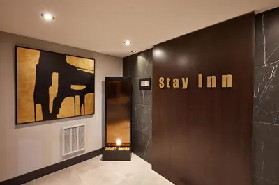 a lobby with a sign that says stay inn at Stay Inn Hotel Toronto in Toronto