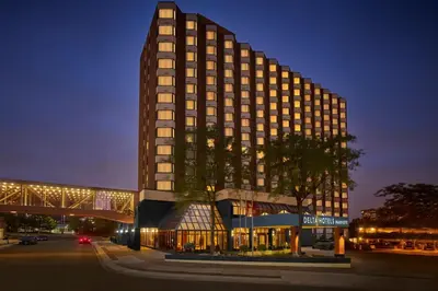 a tall building with lights on it at night at Delta Hotels by Marriott Toronto Mississauga in Mississauga