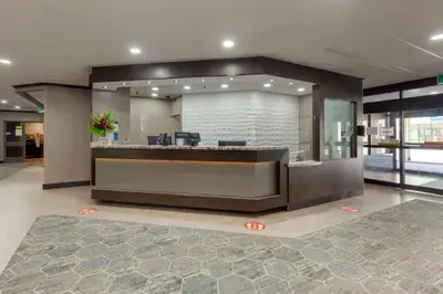 a lobby with a reception desk in a building at Best Western Plus Toronto Airport Hotel in Mississauga