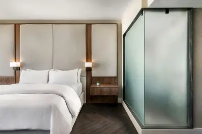 a hotel room with a bed and a glass wall at The Westin Harbour Castle, Toronto in Toronto