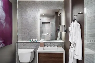 a bathroom with a sink and a toilet and a mirror at The Westin Harbour Castle, Toronto in Toronto